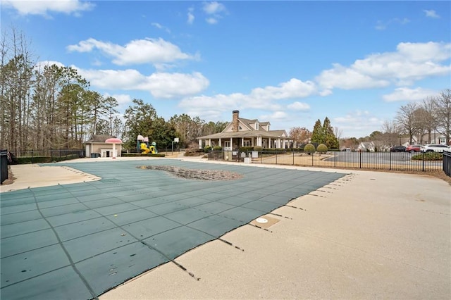 pool with a patio and fence