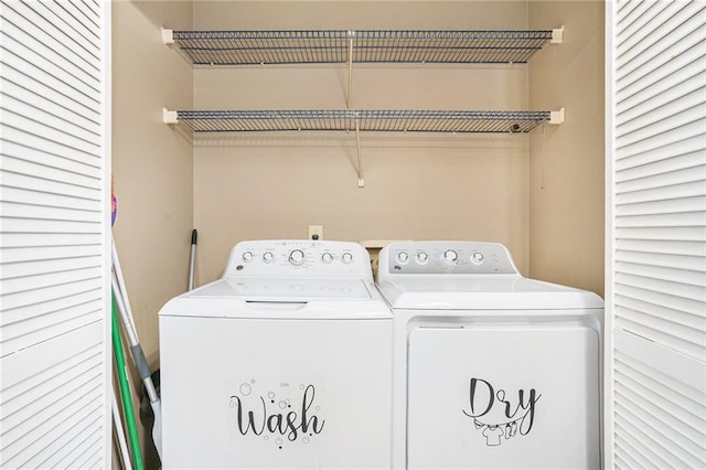 washroom featuring washer and clothes dryer