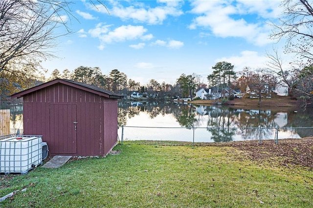 view of yard with a water view and a shed