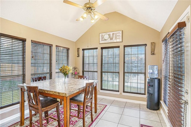 tiled dining room featuring plenty of natural light, ceiling fan, and high vaulted ceiling