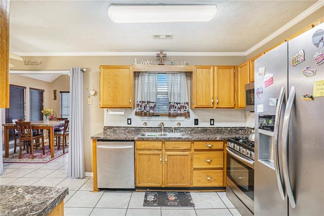 kitchen featuring sink, stainless steel appliances, decorative backsplash, light tile patterned floors, and ornamental molding