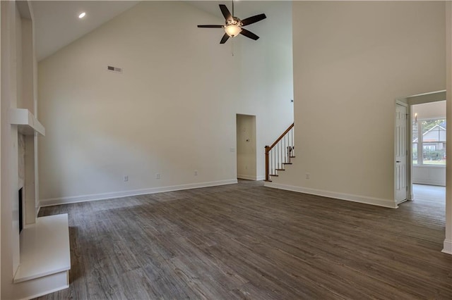 unfurnished living room featuring dark wood-type flooring, high vaulted ceiling, and ceiling fan