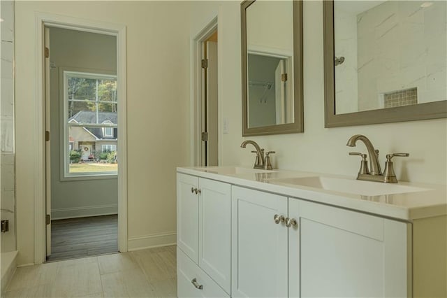 bathroom featuring vanity, walk in shower, and hardwood / wood-style flooring