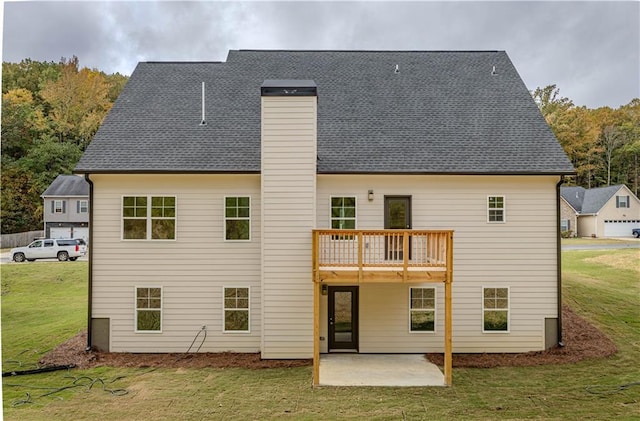 back of house with a yard, a patio, and a balcony