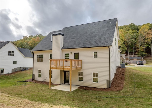 rear view of house featuring a patio area, a yard, and cooling unit