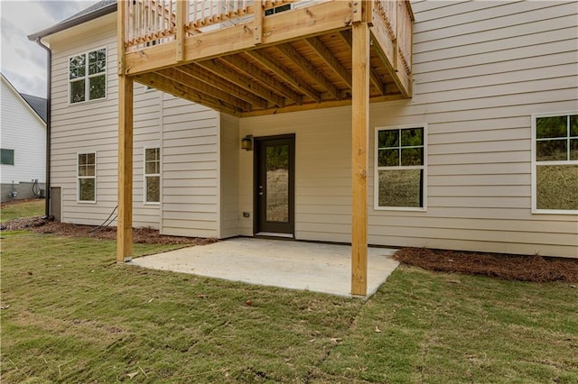 rear view of house featuring a patio and a lawn