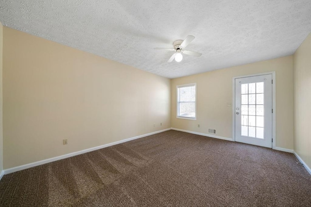 carpeted empty room with a textured ceiling and ceiling fan