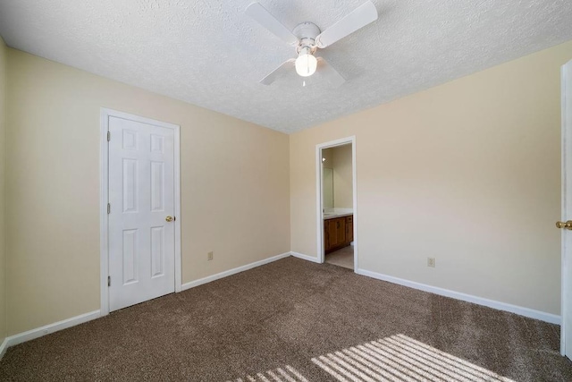 unfurnished bedroom featuring ensuite bath, a textured ceiling, ceiling fan, and carpet flooring