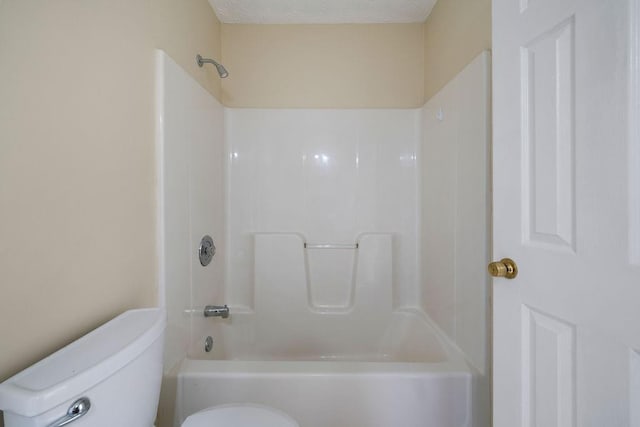 bathroom featuring toilet, a textured ceiling, and shower / bath combination