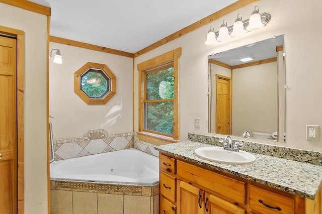 bathroom with tiled bath, crown molding, toilet, and vanity