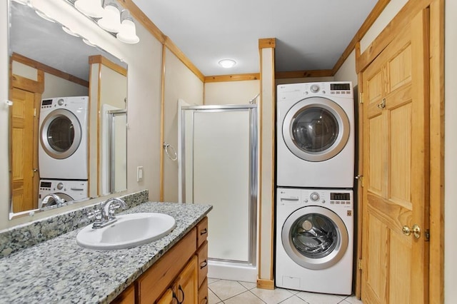 laundry room with stacked washing maching and dryer, sink, light tile patterned floors, and crown molding