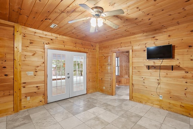 entryway with wooden walls, french doors, wood ceiling, and light tile patterned floors