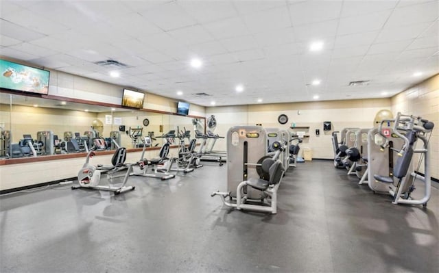 gym with a paneled ceiling