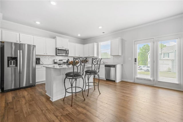 3135 Ellenton Dr, Lithia Springs, GA 30122 - kitchen with a center island, tasteful backsplash, stainless steel appliances, and a kitchen bar