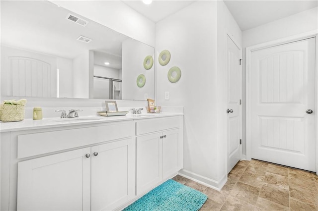 3135 Ellenton Dr, Lithia Springs, GA 30122 - bathroom with visible vents, a sink, baseboards, and double vanity