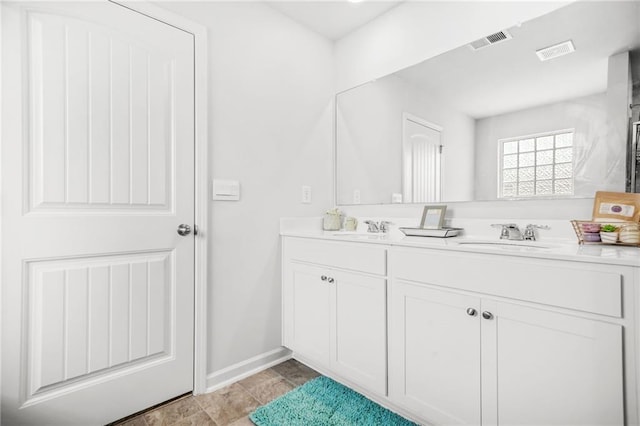 3135 Ellenton Dr, Lithia Springs, GA 30122 - bathroom featuring baseboards, a sink, visible vents, and double vanity