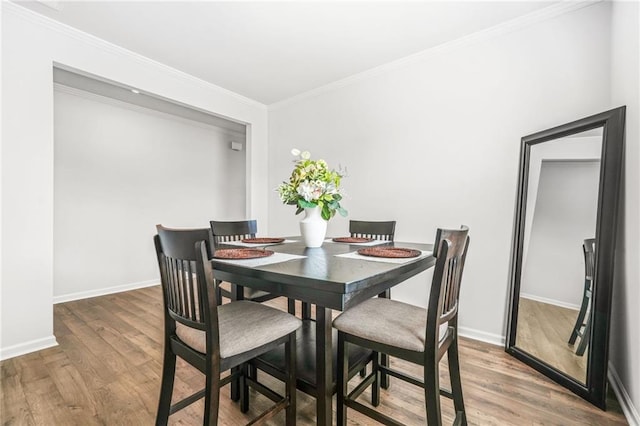 3135 Ellenton Dr, Lithia Springs, GA 30122 - dining area featuring crown molding, baseboards, and wood finished floors