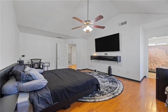 bedroom featuring lofted ceiling, light wood-type flooring, visible vents, and baseboards