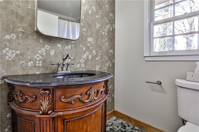 bathroom featuring vanity and toilet