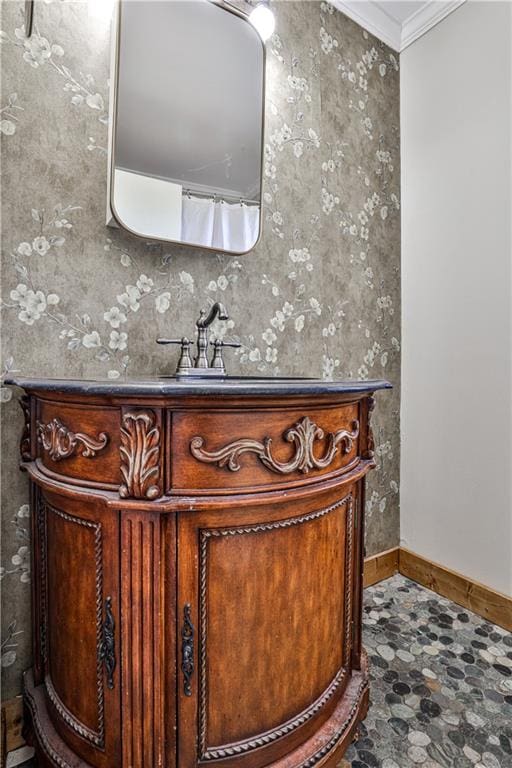 bathroom featuring ornamental molding and vanity