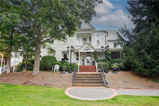 view of front of house with a balcony and a porch