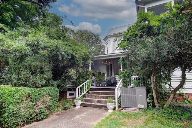 view of front facade with central AC unit and covered porch