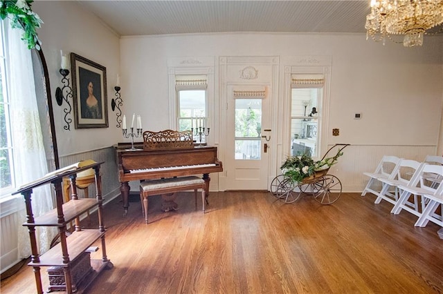 miscellaneous room featuring an inviting chandelier and hardwood / wood-style flooring