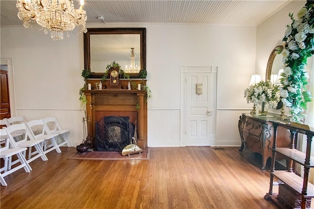 interior space featuring hardwood / wood-style floors, crown molding, and a chandelier