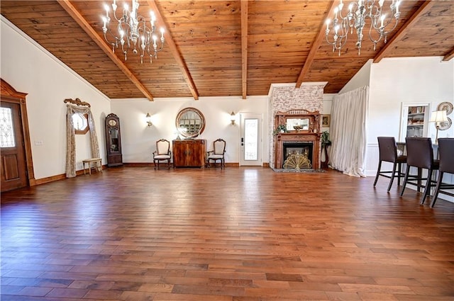 unfurnished living room with a chandelier, a fireplace, dark hardwood / wood-style flooring, and high vaulted ceiling