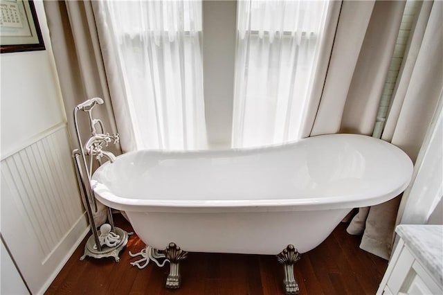 bathroom with a bathing tub and wood-type flooring