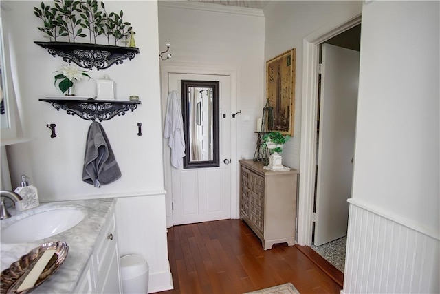 bathroom featuring hardwood / wood-style flooring, vanity, and ornamental molding