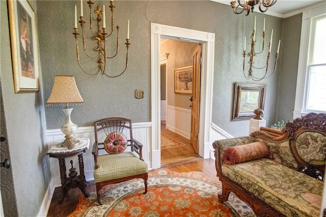 sitting room featuring an inviting chandelier, a healthy amount of sunlight, and light hardwood / wood-style floors