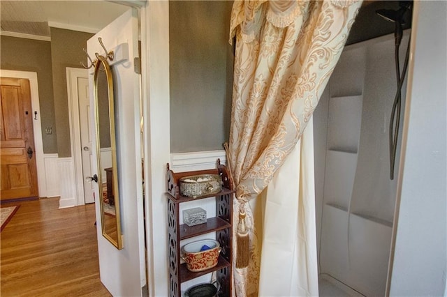 interior space featuring crown molding and hardwood / wood-style floors