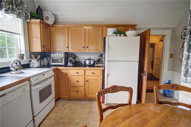 kitchen with white appliances and vaulted ceiling