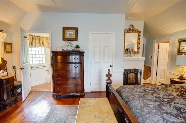 bedroom featuring dark hardwood / wood-style flooring and vaulted ceiling