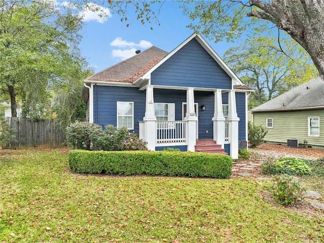 bungalow-style house featuring a front lawn, central AC, and covered porch