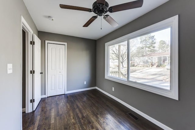 284 Barfield Ave SW, Atlanta, GA 30310 - unfurnished bedroom with baseboards, dark wood finished floors, a closet, and a ceiling fan
