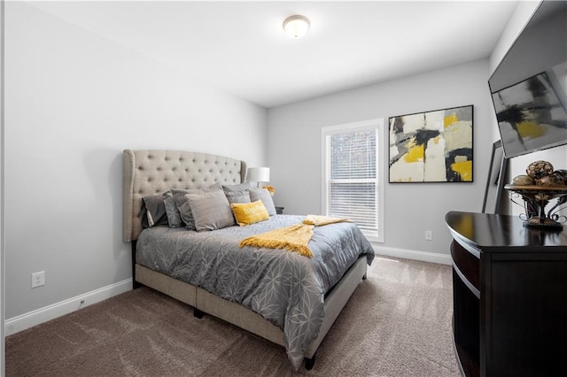 bedroom featuring carpet and baseboards