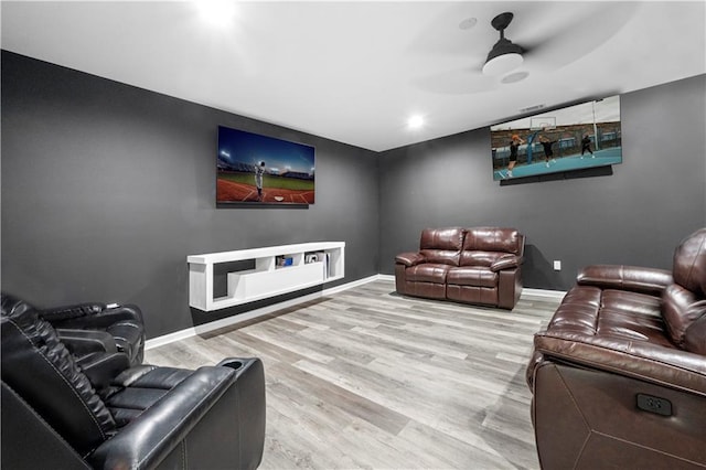 home theater room featuring baseboards and wood finished floors