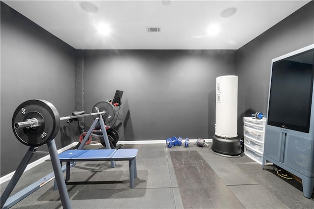 exercise room with baseboards and visible vents