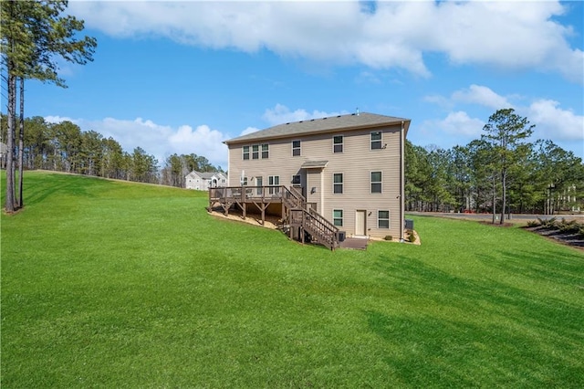 rear view of property with stairway, a lawn, and a deck