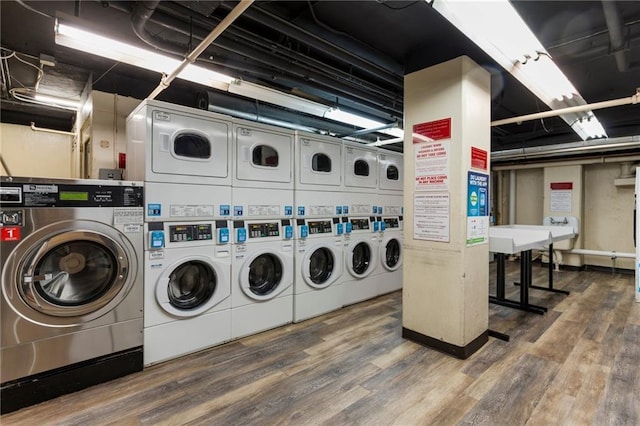 common laundry area featuring stacked washer and dryer, wood finished floors, and washer and dryer