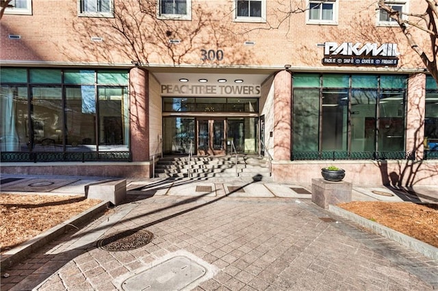 entrance to property featuring brick siding