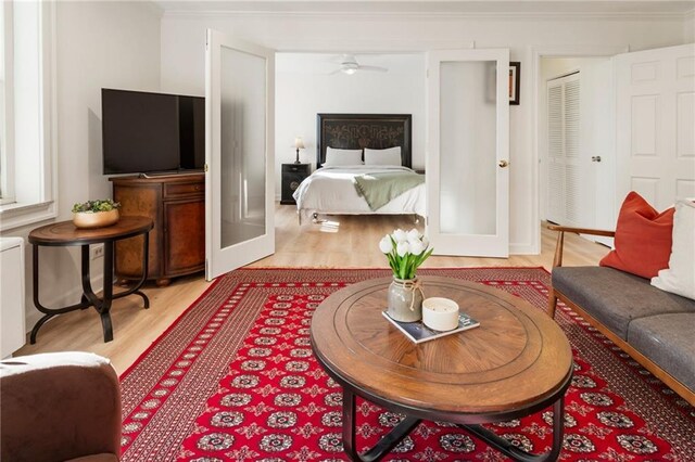 interior space featuring ornamental molding, french doors, and light wood finished floors