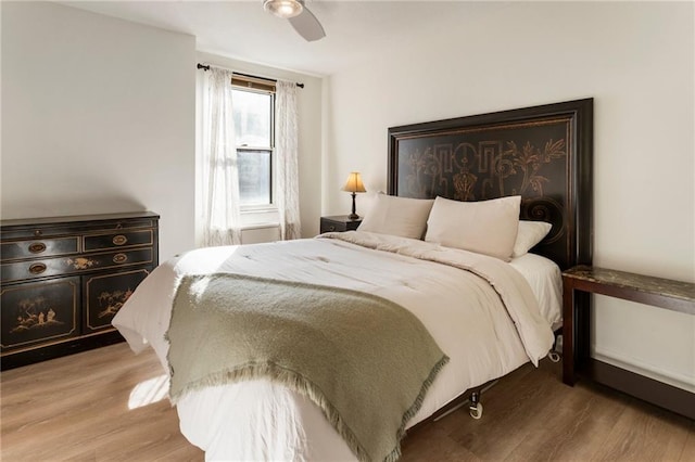 bedroom with ceiling fan and light wood-style flooring