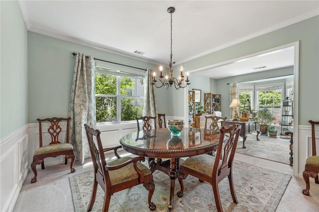 5415 Fieldfreen Dr, Cumming, GA 30028 - dining room with a chandelier, light carpet, a decorative wall, a wainscoted wall, and crown molding