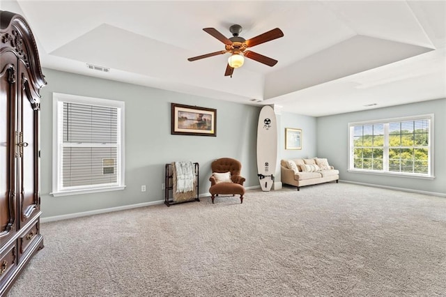 5415 Fieldfreen Dr, Cumming, GA 30028 - living area featuring carpet floors, a raised ceiling, a ceiling fan, and baseboards
