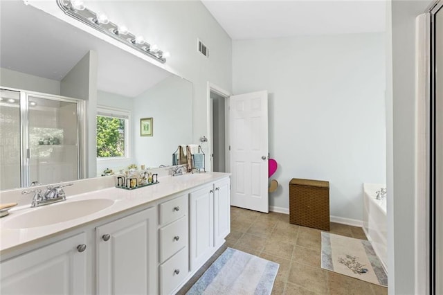 5415 Fieldfreen Dr, Cumming, GA 30028 - full bath with a shower stall, double vanity, a garden tub, tile patterned flooring, and baseboards
