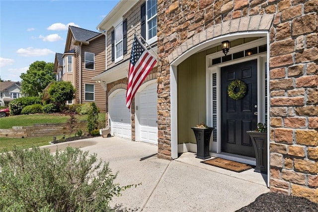 5415 Fieldfreen Dr, Cumming, GA 30028 - property entrance featuring concrete driveway, stone siding, and a garage