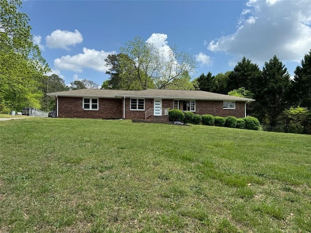 single story home with brick siding and a front lawn